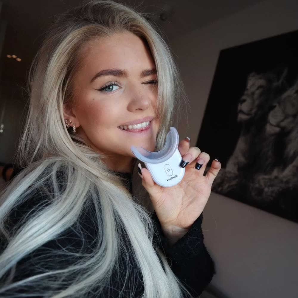 Wilma Tillander holding the LED booster with the tray