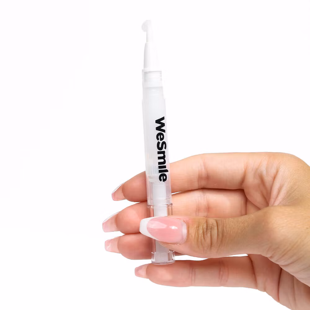 A hand holding a WeSmile gel pen