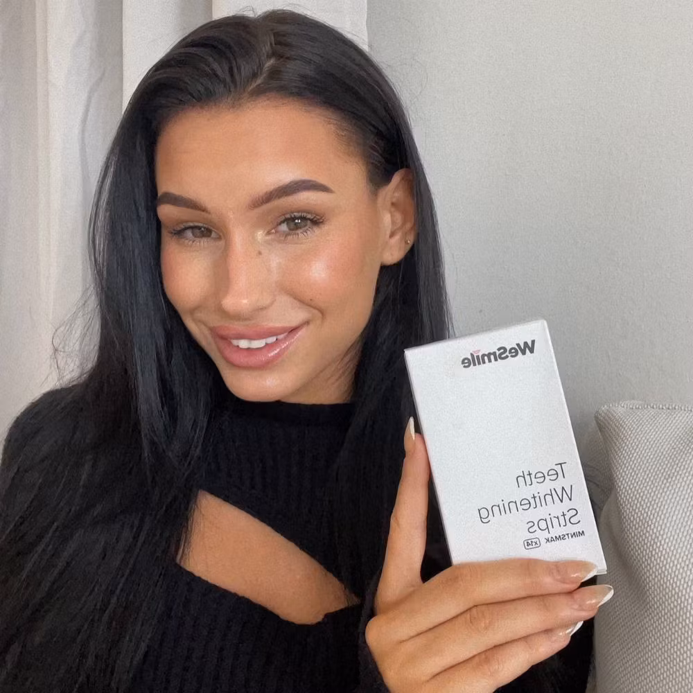 A woman holding the strips box